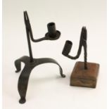 A wrought iron nip rushlight holder, with candle socket, square oak base, 20cm high; another,