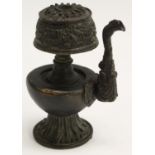 A Tibetan/Chinese dark patinated bronze water dropper, lotus base, 12.