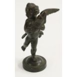Grand Tour School (19th century), a dark patinated bronze, of a putto holding a dolphin,