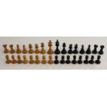 A boxwood and ebony Staunton pattern chess set, the pieces marked for King's side, the kings 7.