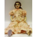 A late 19th century wax and composite doll, wax head and limbs, brown glass eyes,