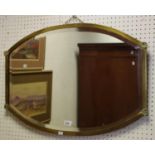 An early 20th century brass shaped mirror, scallop shaped corners c.