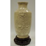 An oriental crackle glazed baluster shaped vase decorated with flowering prunus sprigs with carved
