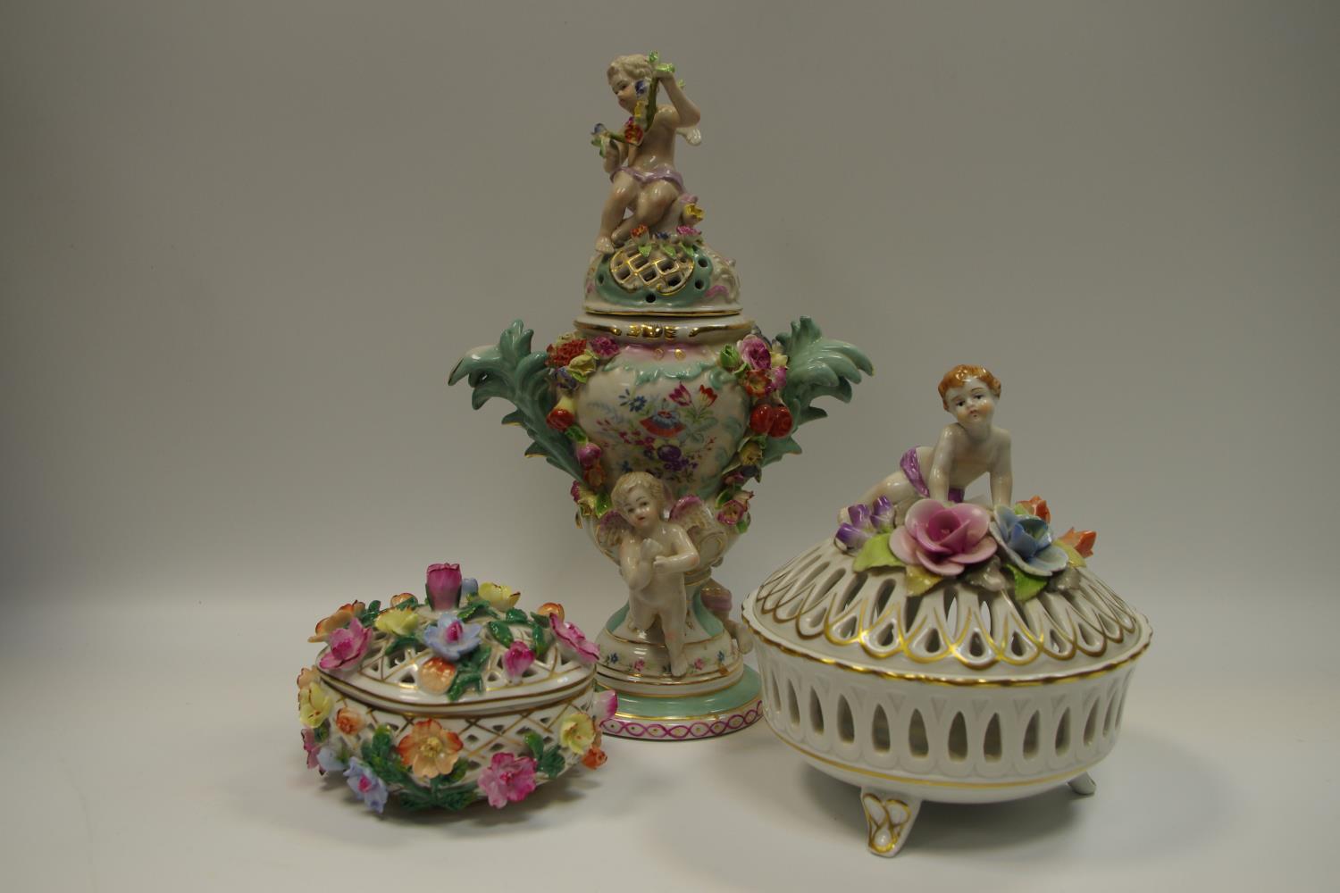 An Augustus Rex 19th century Dresden porcelain twin handled urn and cover decorated with putti and