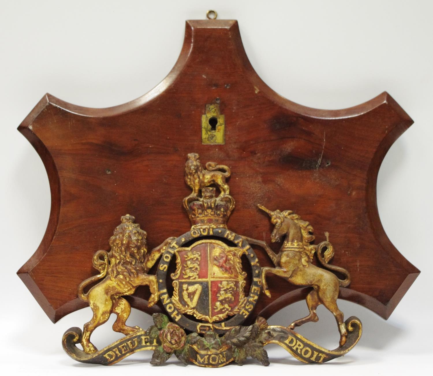 A cast Royal coat of Arms armorial on mahogany plaque