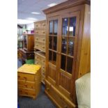 A modern pine double wardrobe, two three quarter glazed doors top top,