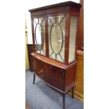 An Edwardian flame mahogany display cabinet, outswept cornice,