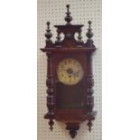 An early 20th century mahogany wall clock flanked by pilasters c.