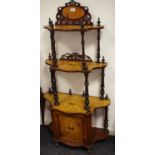 A Victorian walnut whatnot/cabinet with mirrored gallery with shaped tiers,
