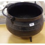 A cast iron three legged cauldron circa 1900.