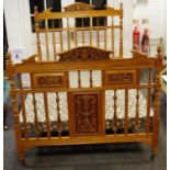 A Victorian satinwood double bed with acanthus scrolled carvings c.