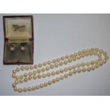 A pair of 9ct gold pearl stud earrings in original fitted box; a string of pearls,