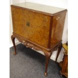 A reproduction walnut drinks cabinet,