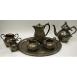 A palnished pewter coffee pot; creamer, sucrier and oval tray; a three piece plated tea set.