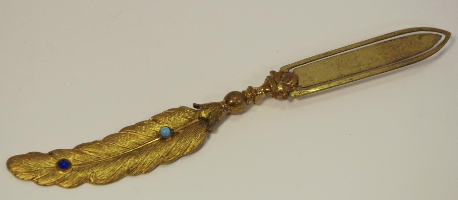 A late 19th/early 20th century gilt metal novelty book mark in the form of a quill,