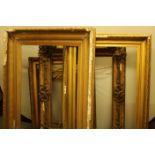 A large gilt and gesso frame, 124cm x 94cm, internal 91cm x 61cm; others, 10cm x 91cm,