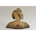 A French Art Nouveau style painted terracotta bust of a young beauty,