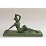After Melani, a French Art Deco style, painted plaster model of a reclining nude, scantiliy draped,