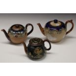 A Doulton Slaters patent globular teapot and cover, tube lined with leaves and berries, in tan,