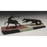 Art Deco, a spelter group, of a stag being chased by two greyhounds,