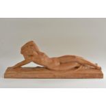 After Bouraine, a French Art Deco style terracotta model of a reclining scantiliy draped nude,