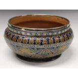 A Doulton Lambeth salad bowl, designed by Edith Lupton, incised with stylised leaves,