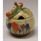 A Clarice Cliff Crocus pattern 'orange' preserve pot and cover, painted in colours with crocuses,