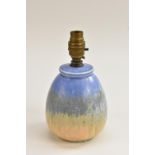 A Ruskin Pottery ovoid table lamp, glazed in mottled bands of blue, green and orange,