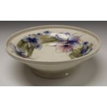 A Moorcroft Orchid pattern pedestal bowl, tube lined with large flowerheads on white ground,