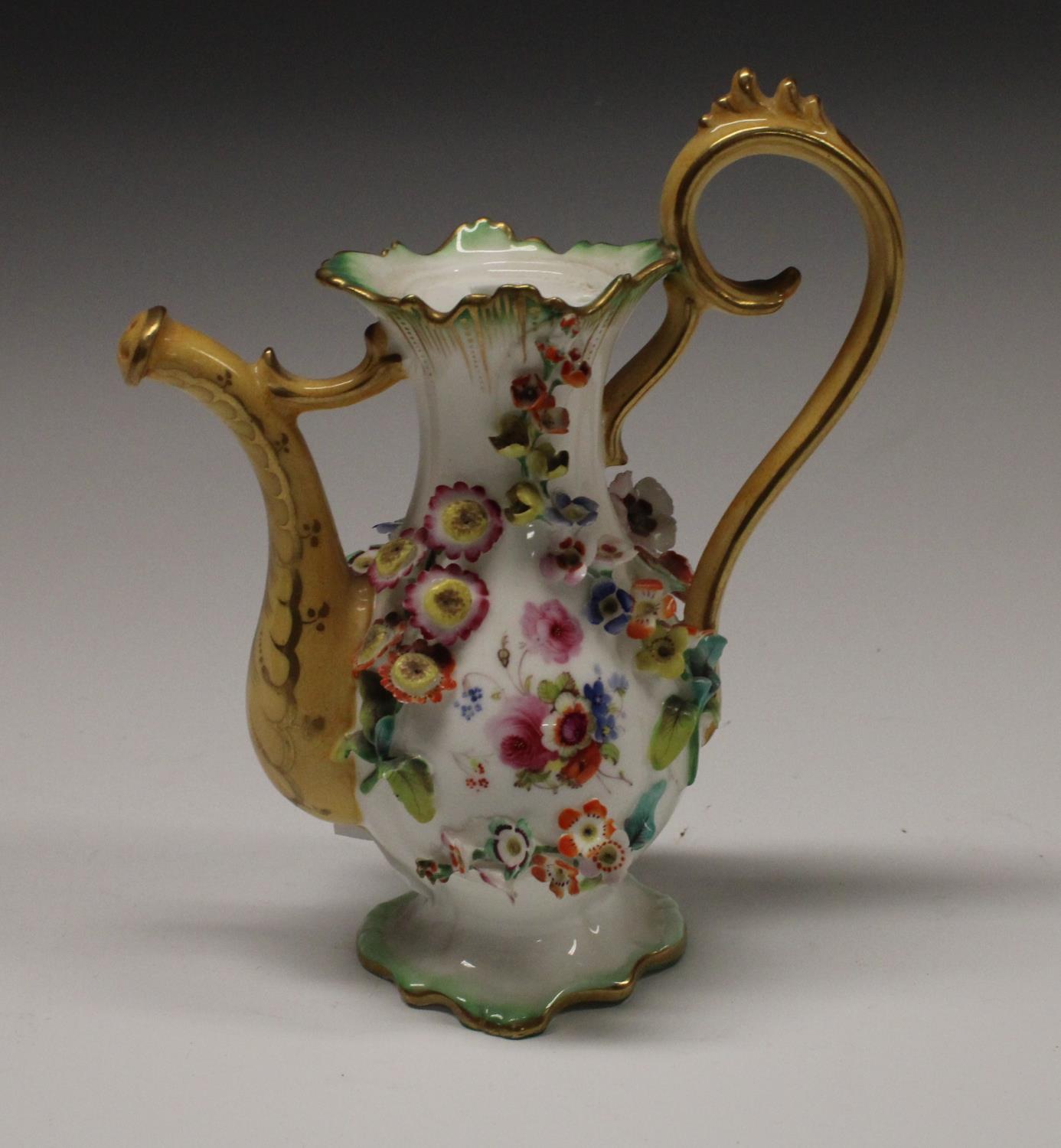 A Rockingham type novelty miniature coffee pot, encrusted with flowers, 16cm high, c.