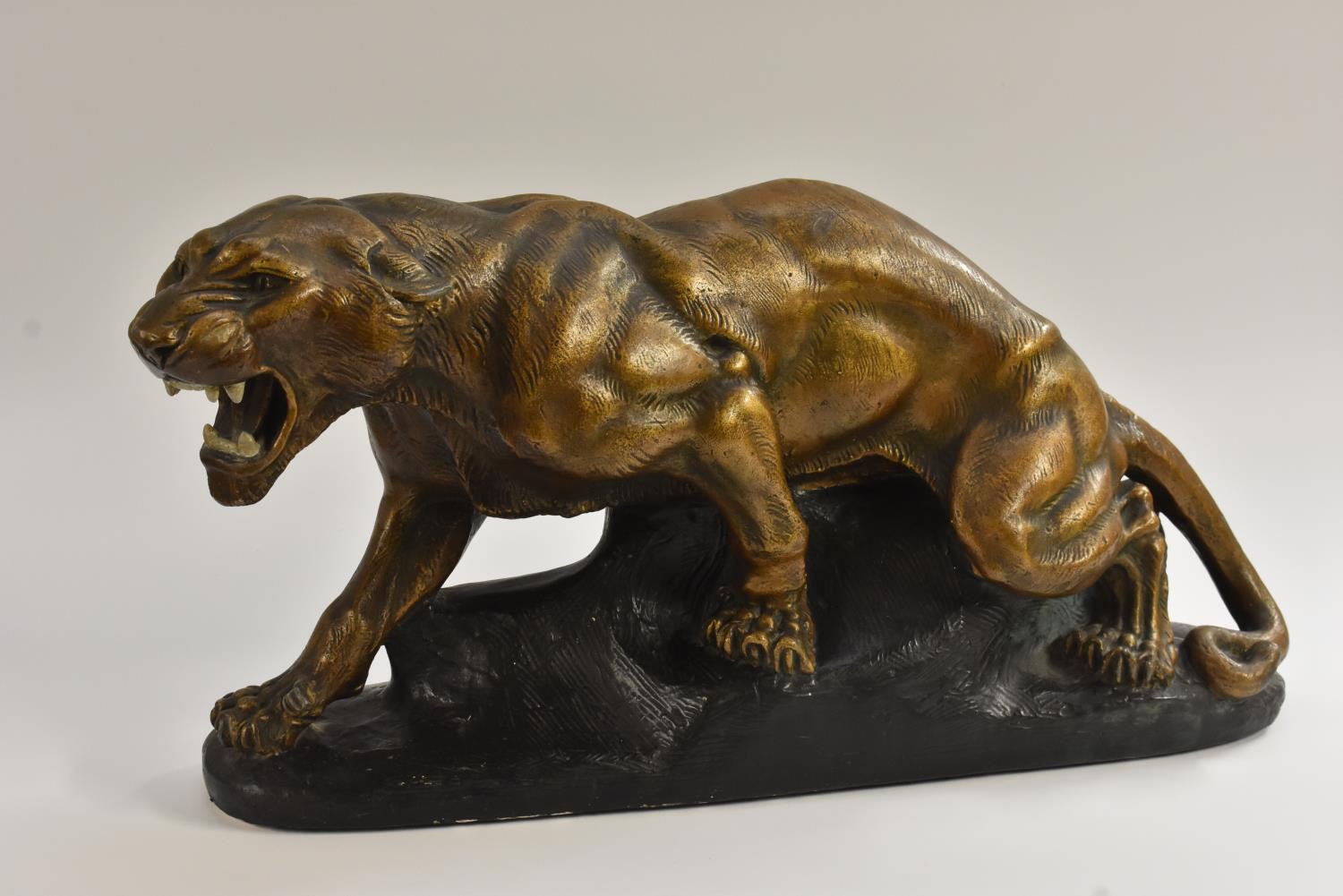 A French Art Deco style model of a snarling panther, the painted plaster body with bronzed effect,