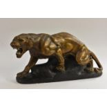 A French Art Deco style model of a snarling panther, the painted plaster body with bronzed effect,