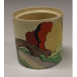A Clarice Cliff Lorna cylindrical preserve pot, brightly painted with a bridge and trees, 6.