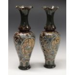A pair of Doulton Lambeth slender baluster vases,