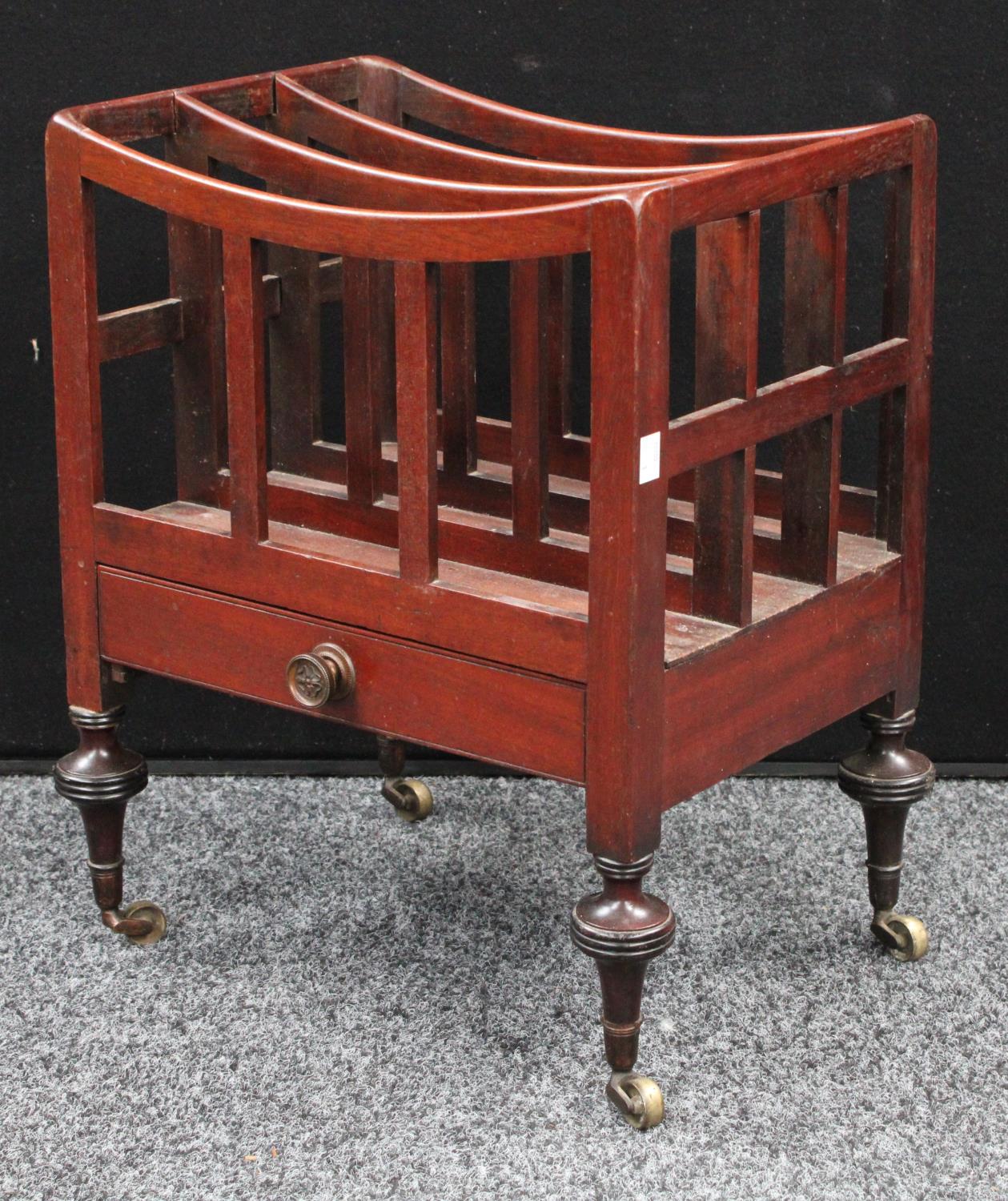 A George III mahogany Canterbury, of small proportions, three divisions, apron drawer, casters,