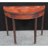 A George III mahogany demilune tea table, folding top with concave edge above a deep frieze,