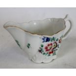 A Worcester low Chelsea ewer, painted with coloured flowers, gilt line border, c.