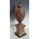 A Neo-Classical style fossil stone urn, pine cone finial, square plinth,