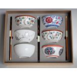 A set of six Chinese enamelled bowls in traditional patterns with chop-sticks en-suite,