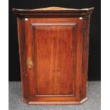 A George III oak corner cupboard,