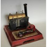 A Bing tinplate tinplate live steam model stationery engine, copper-bound brass tank,