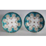 A pair of Minton shaped circular cabinet plates, painted with swags of colourful flowers,