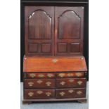 An unusual and substantial mid-18th century oak bureau bookcase/cabinet,
