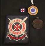 A Royal Life Saving Society award of merit; a similar cloth badge; a similar medallion,