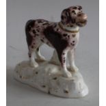 A 19th century english Staffordshire porcelain dog, modelled standing,