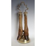 A 19th century brass and taxidermy door porterm shaped carrying handle above two deer hooves and