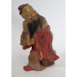 A Chinese soapstone carving, of Shou Lao, clutching the peach symbolic of longevity,