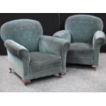 A pair of early-mid 20th century armchairs, shallow button back,