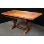 An early 20th century oak draw-leaf dining table, substantial baluster supports, c.