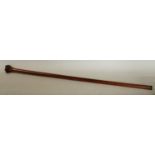 A 19th century gentleman's novelty walking cane, the oak pommel carved as a hand grasping a rod,